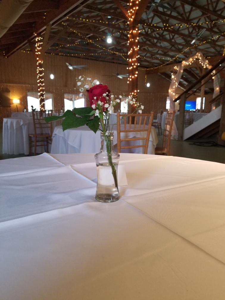 A single rose on a set table