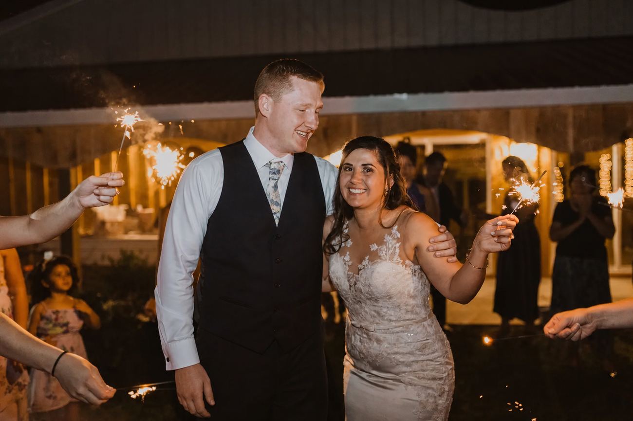 A sparkler send-off outside the barn