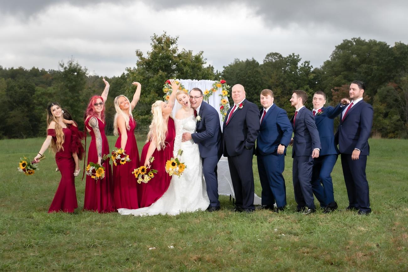 A wedding party with sunflower bouquets on the lawn