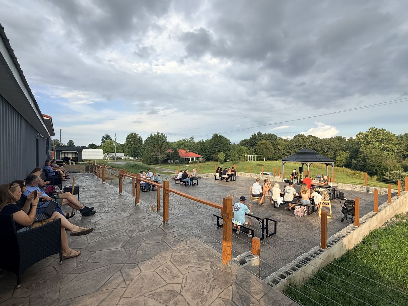 Guests on the patio watching live music at the gazebo