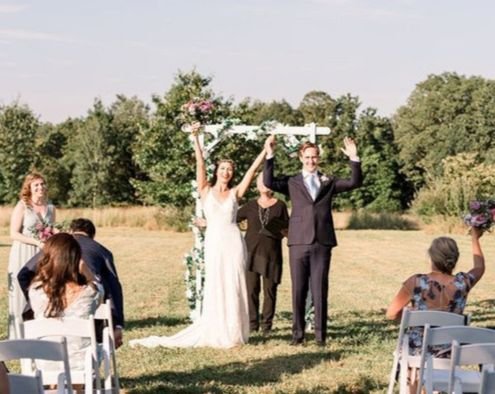 Just married — the couple cheering at the end of the aisle