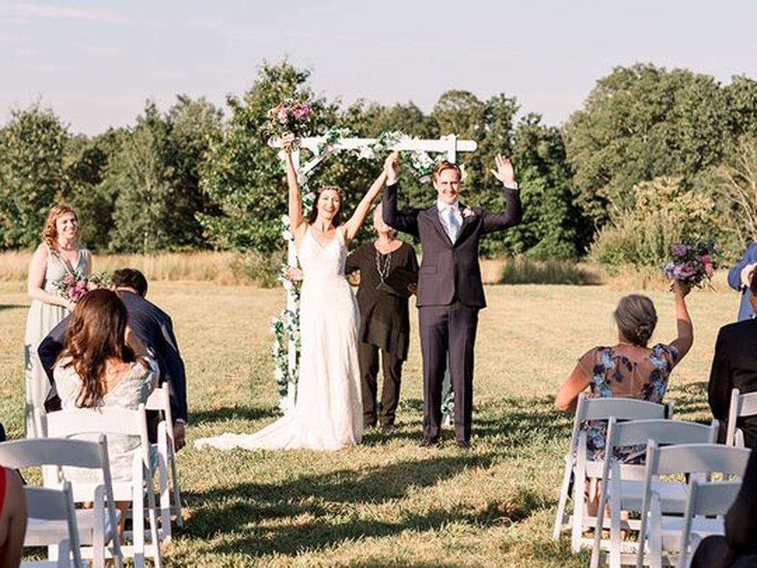Just married — the couple cheering at the end of the aisle