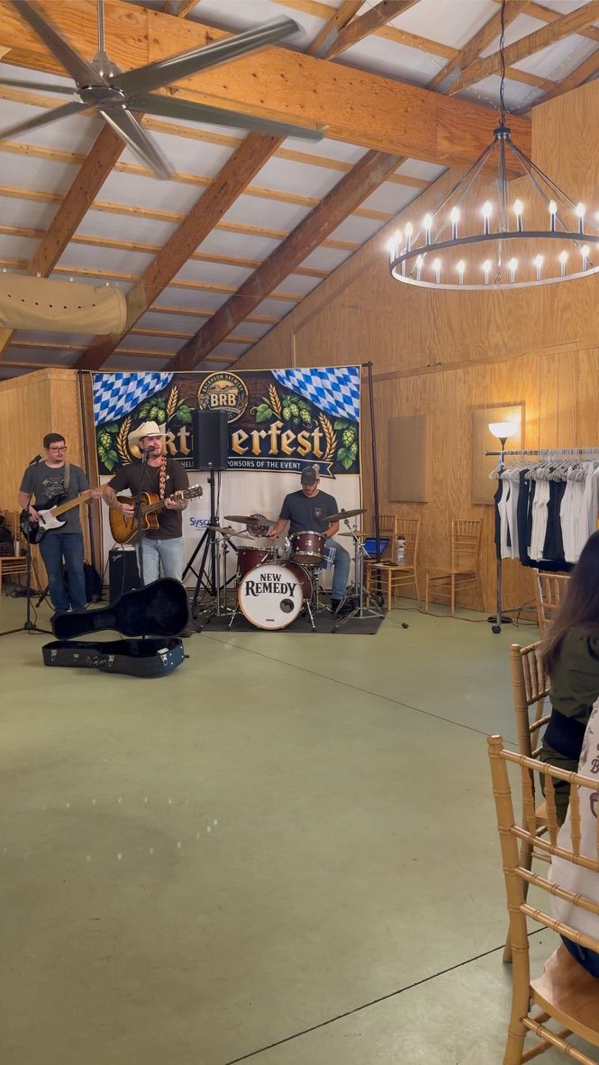 The band seen from the tables across the barn floor, a chandelier lit overhead