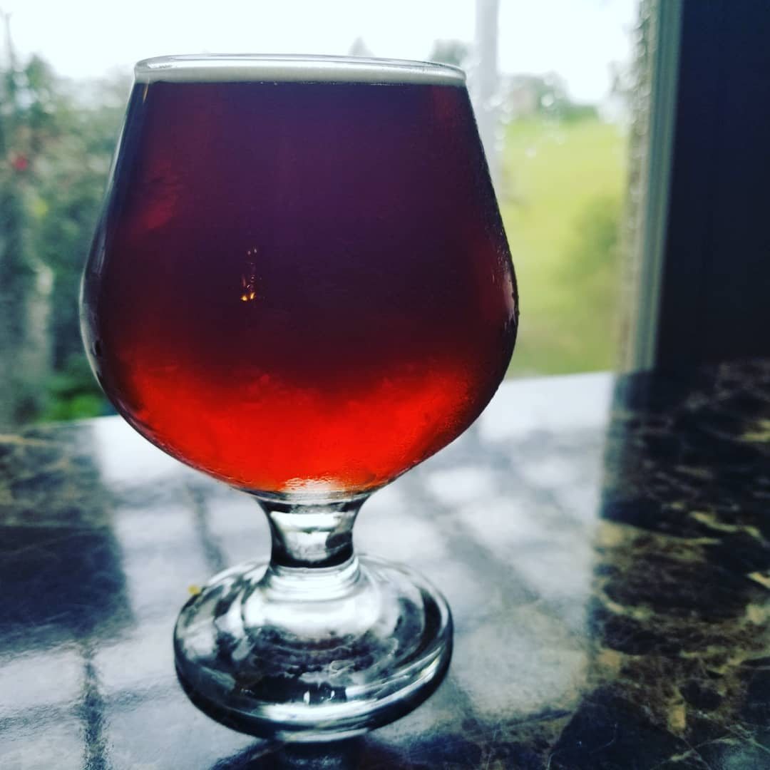 A glass of amber Oktoberfest Märzen by the window