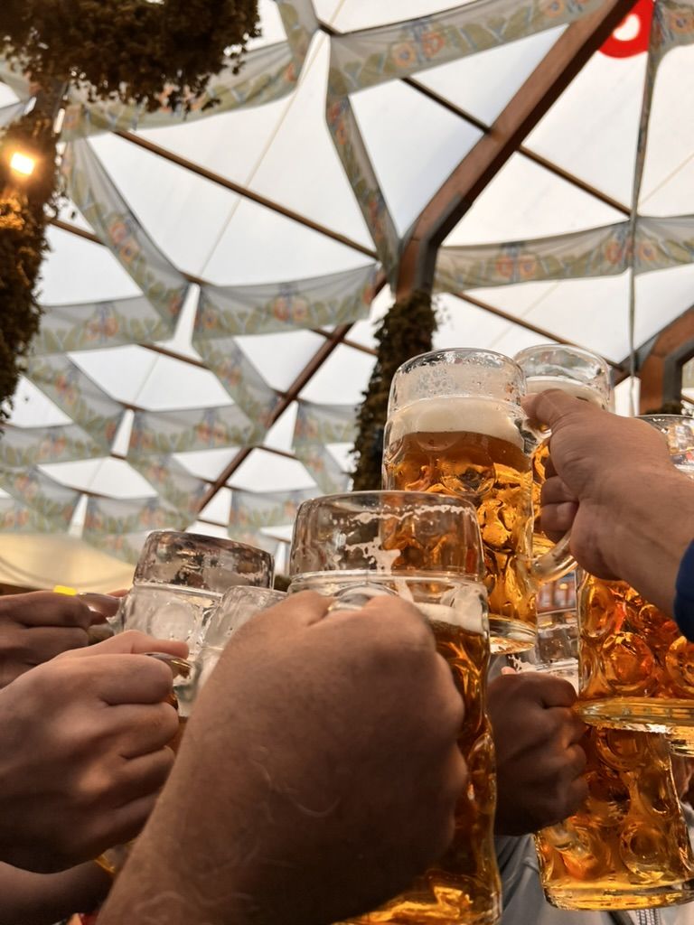 Steins raised under the festival tent