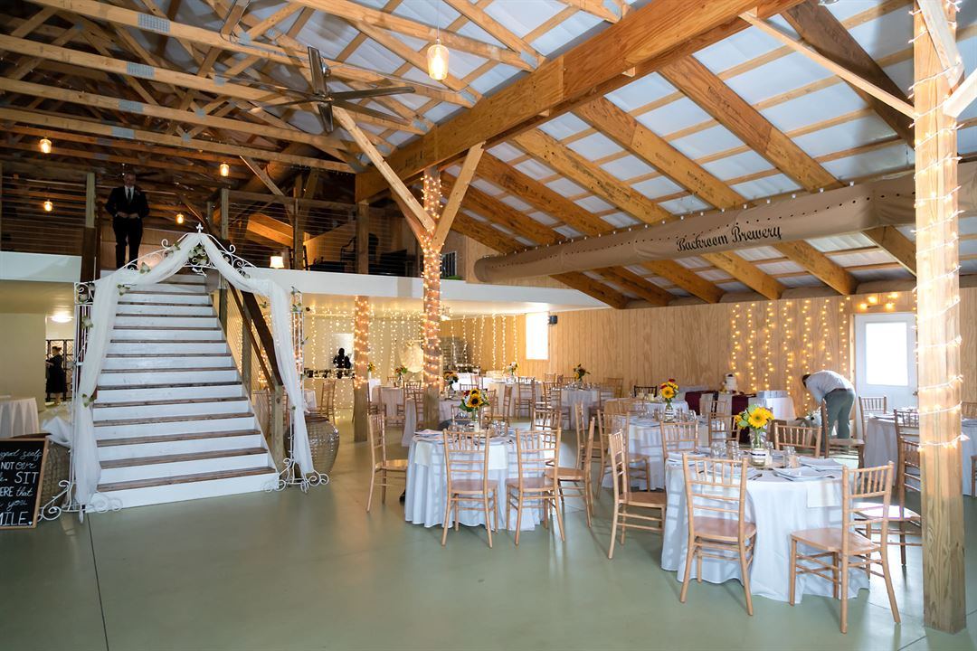 The barn set for a celebration with sunflowers