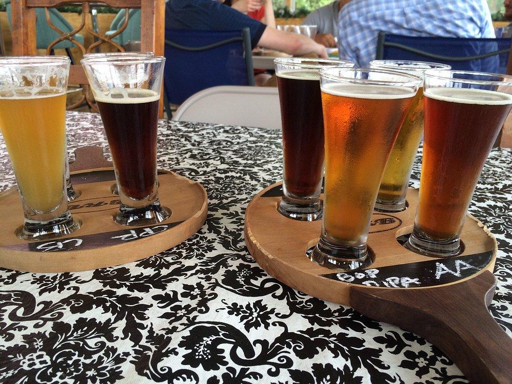 Two flights of beer on a patio table